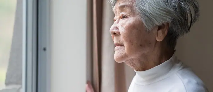elderly woman looking out the window