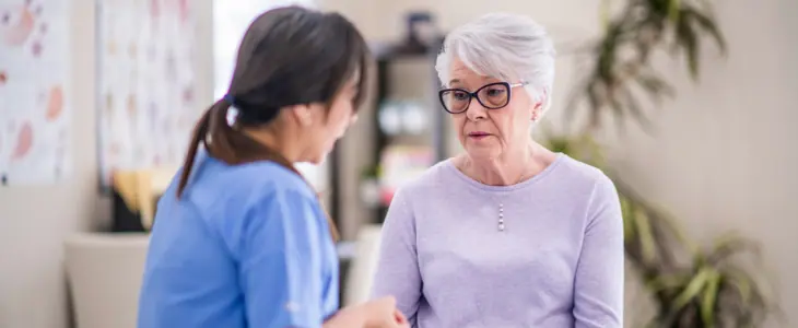sad elderly woman at doctor